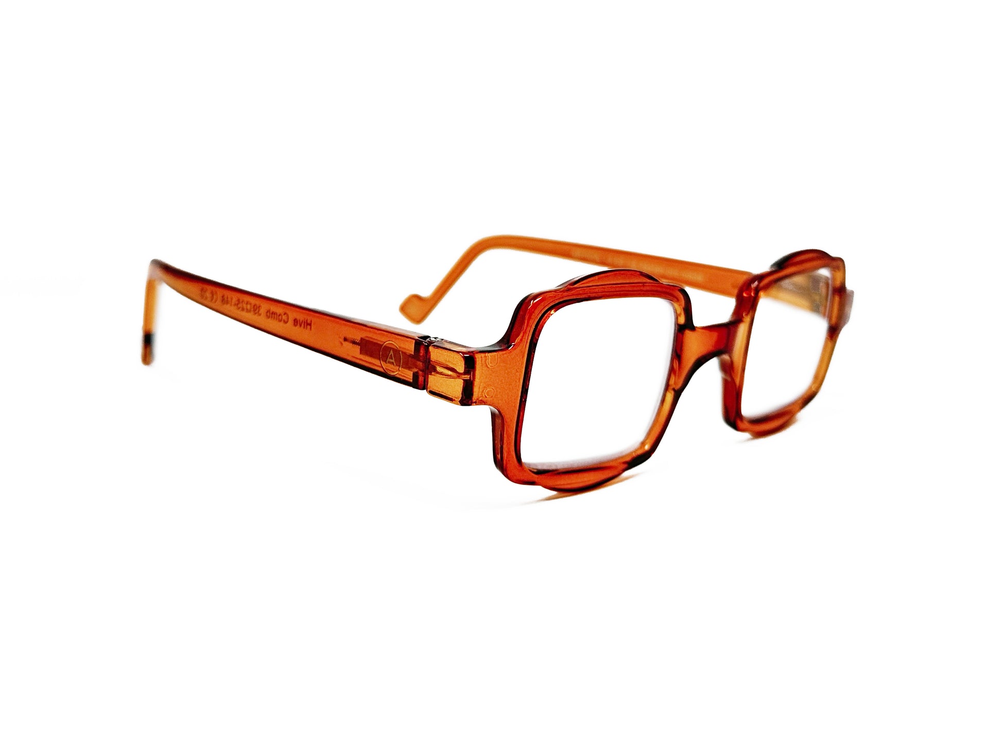 Aptica square reading glass with half-circle shape on top and bottom . Model: Hive. Color: Sticky Honey - Honey orange, Semi-transparent. Side view.