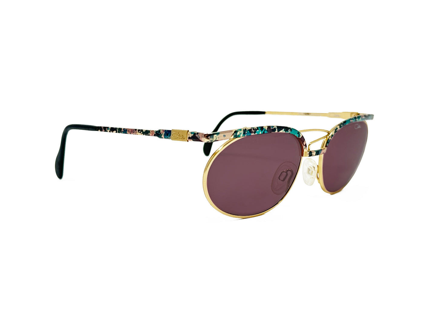 Cazal oval, metal sunglass with green tortoise bar across each lens and spiral wire on nose bridge. Model: 263/3. Color:425 Gold metal with green tortoise pattern. Side view.