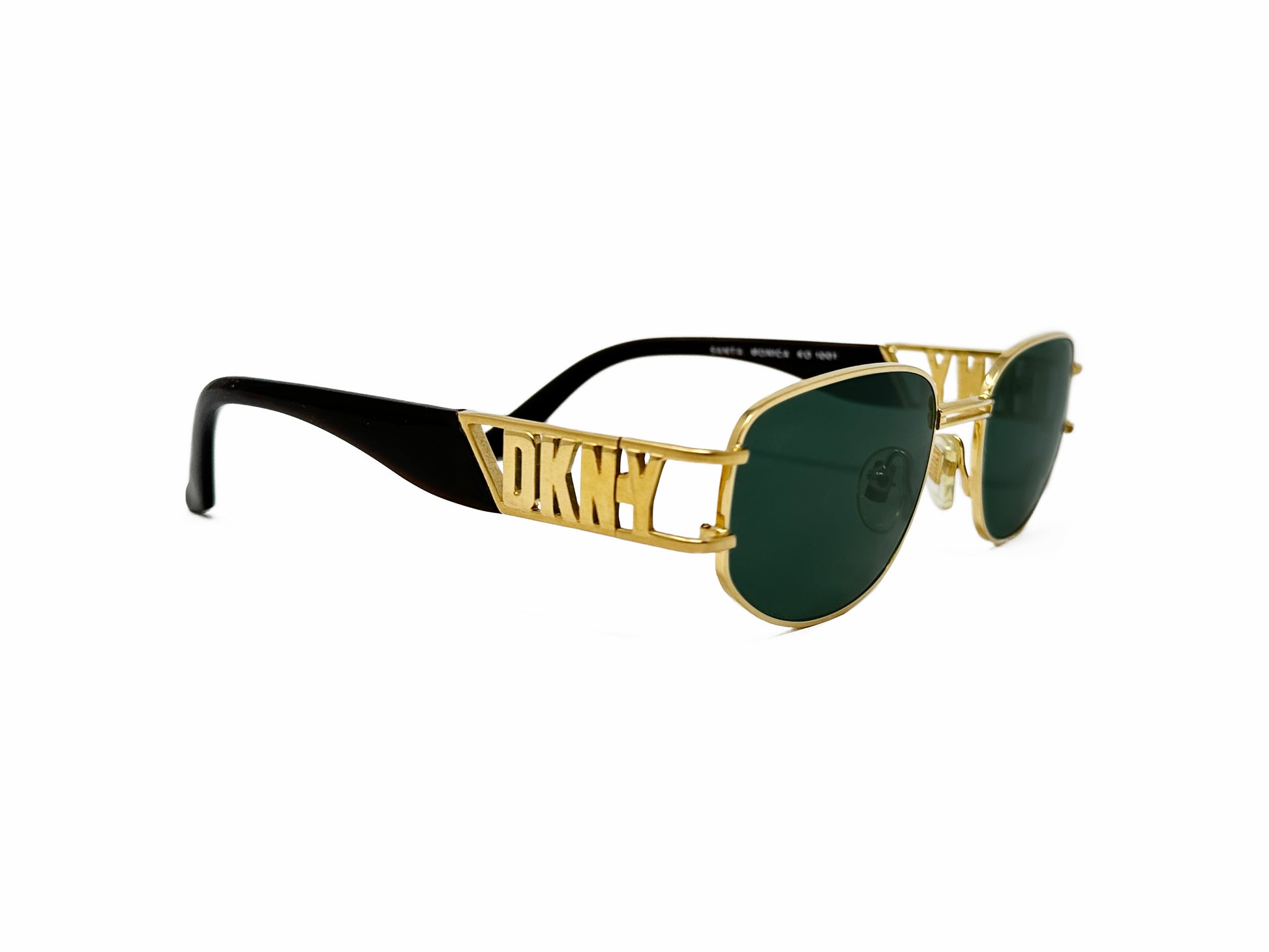 DKNY rounded, slightly angled, square, metal sunglasses with DKNY letters on side of temples. Model: Santa Monica. Color: 1001 - Gold with green lenses and gold/black temples. Side view.