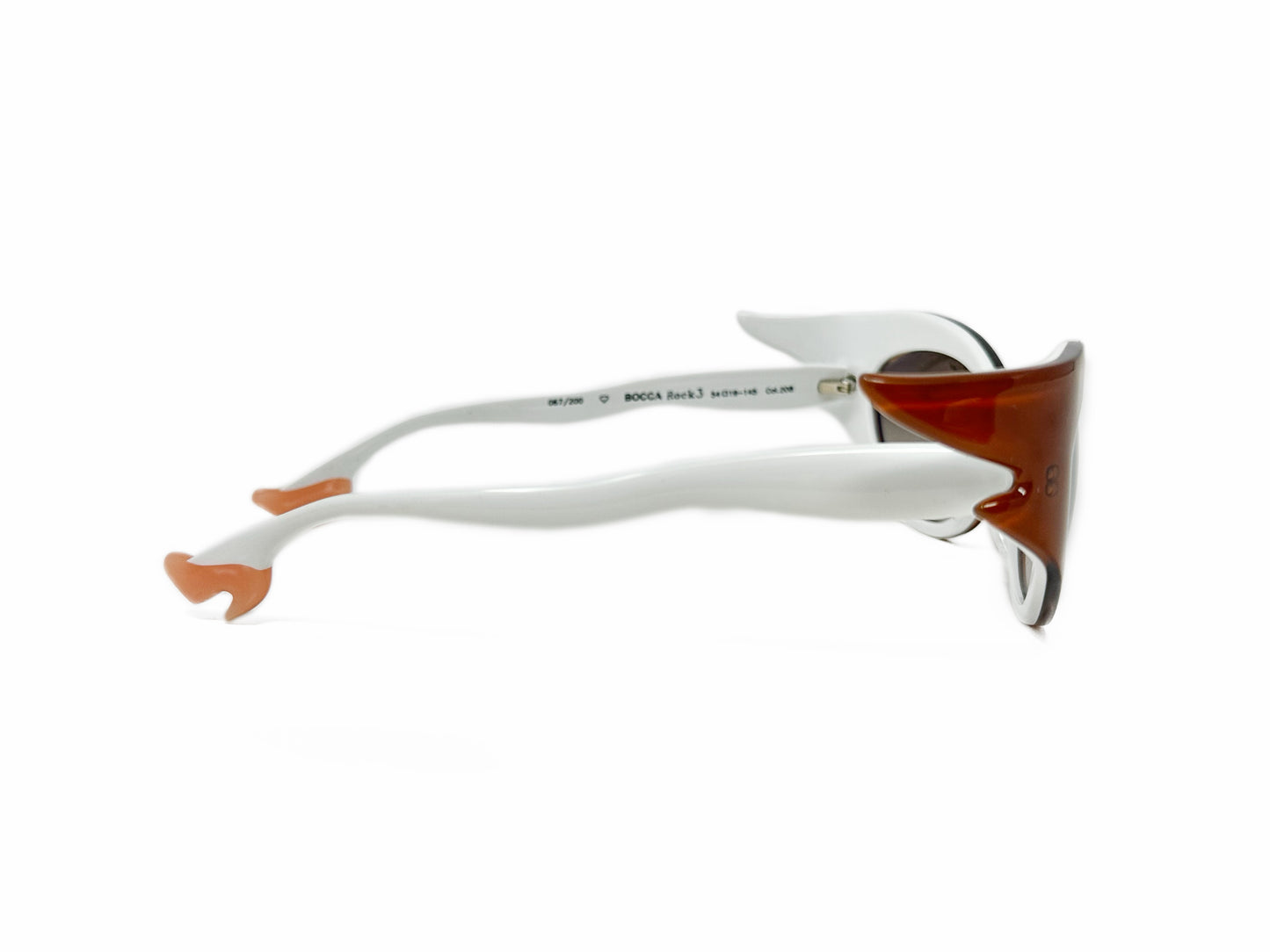 Face a Face acetate, cat-eye sunglass with winged corners and temples that look like legs wearing heels. Model: BoccaRock3. Color: 208 - Burnt Sienna with white legs and peach heels. Side view.