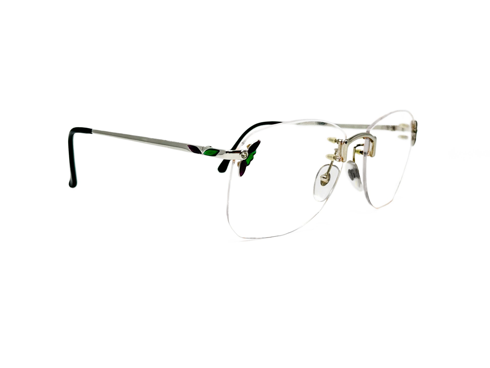 Luxottica metal rimless optical frame with flowery accent on corner near hinge. Model: 7572. Color: P413 - Silver metal with green accents. Side view.