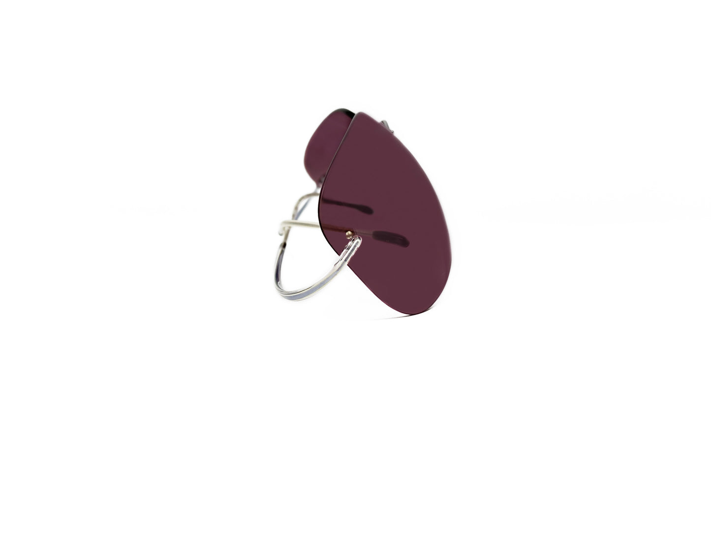 Silhouette rimless sunglass with rose lens. Model: 7499. Color: 6050- Silver with rose lens. Side view.
