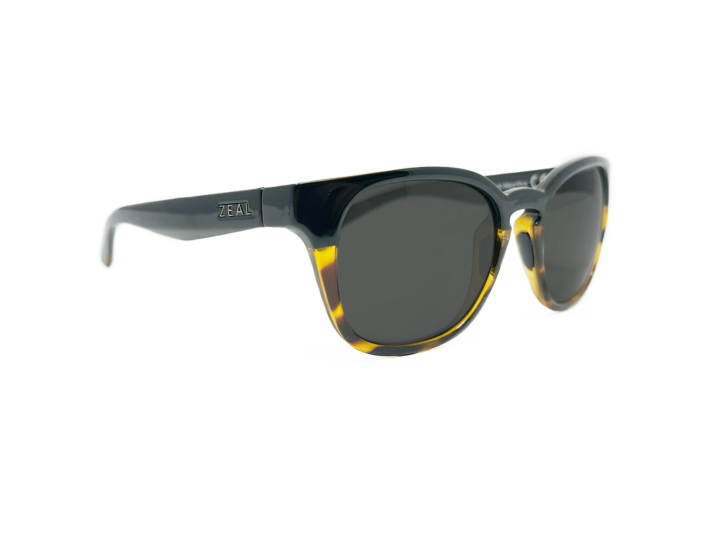 Zeal Optics tall, rounded, wayfarer style sunglass with keyhole bridge. Model: Windsor. Color: 11477 - Black on top, yellow havana on bottom. Side view.