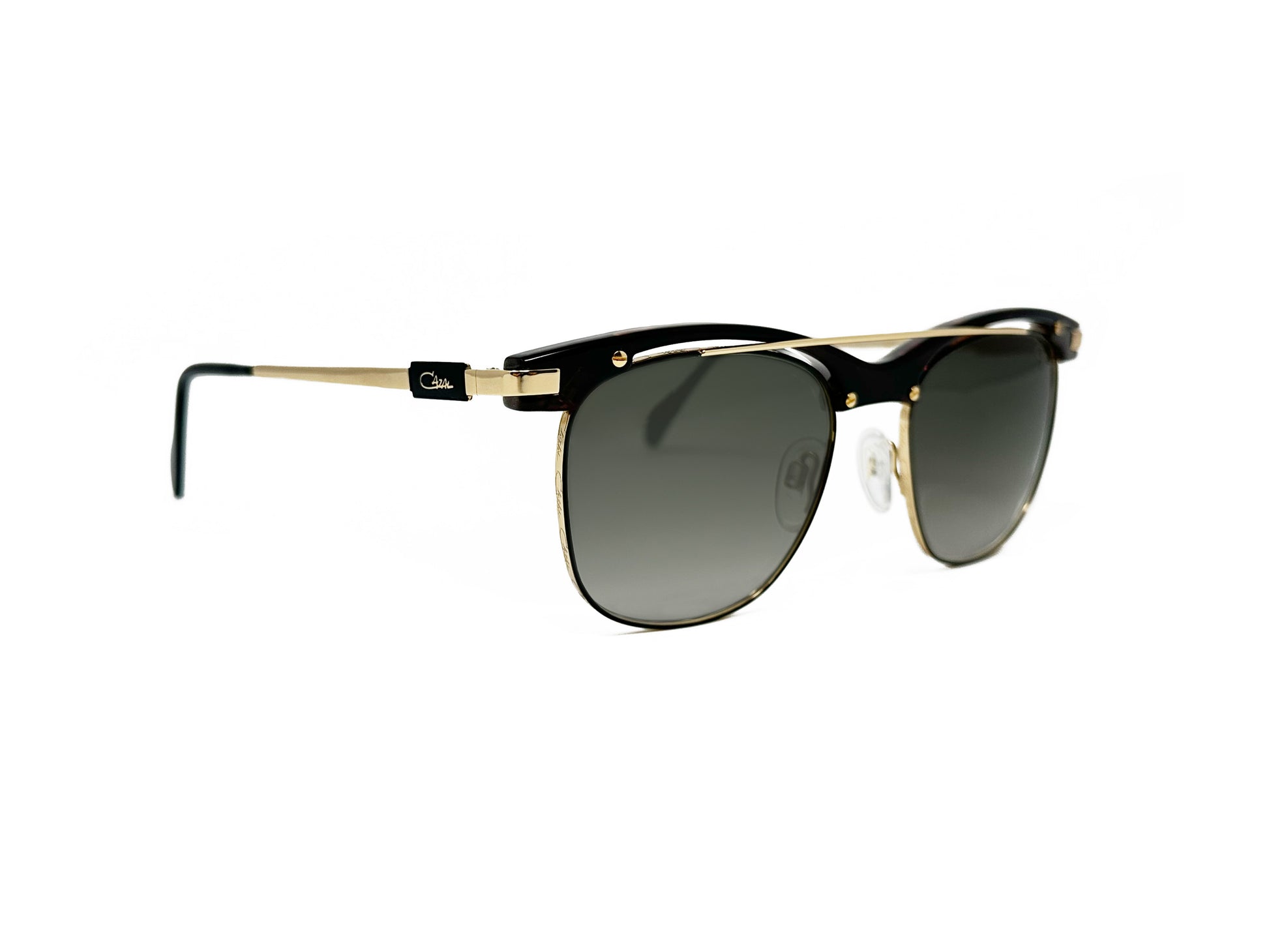 Cazal half-rim, clubmaster style sunglass with gold, curved, metal bar across top of frame and screw embellishments. Model: 9084. Color: 003 - Tortoise and gold metal. Side view.