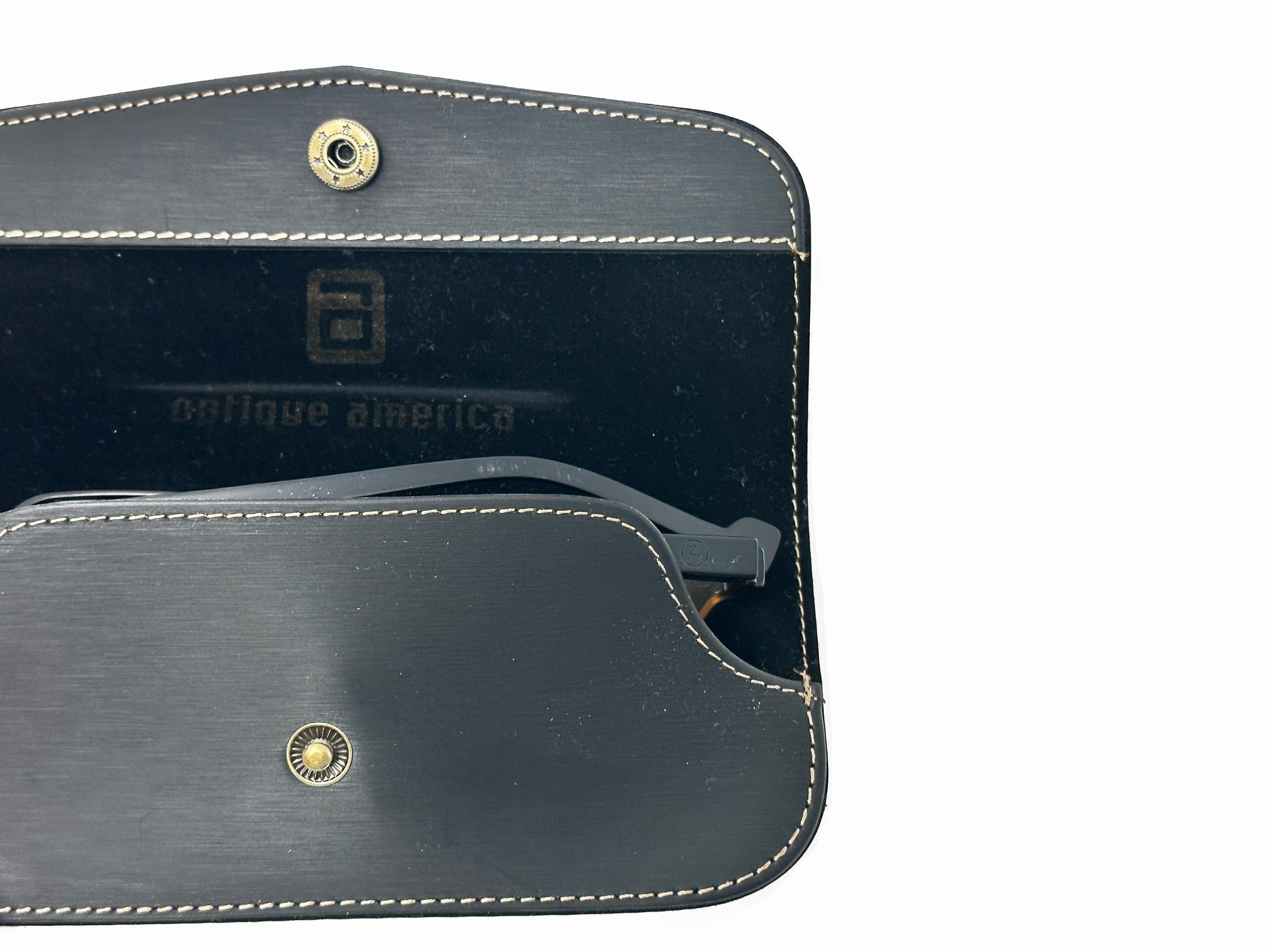 Inside of black leather snap case with Optique America logo