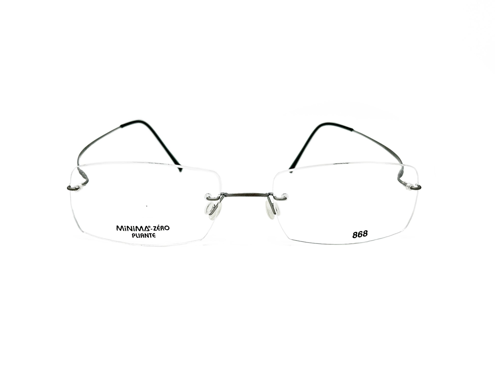 MInima rectangular, titanium, rimless, optical frame with thin curbed temples. Model: 868. Color: 79 - Silver. Front view.  