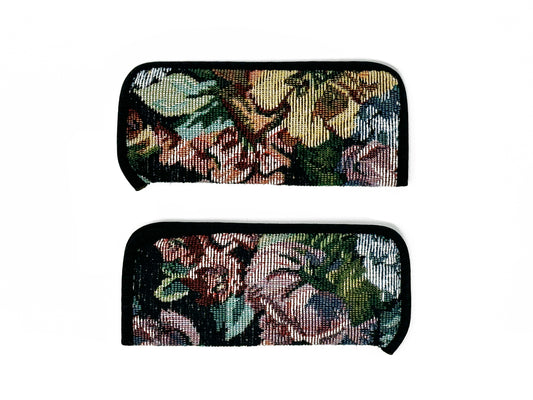 Stitched eyewear case with floral pattern and black border. 